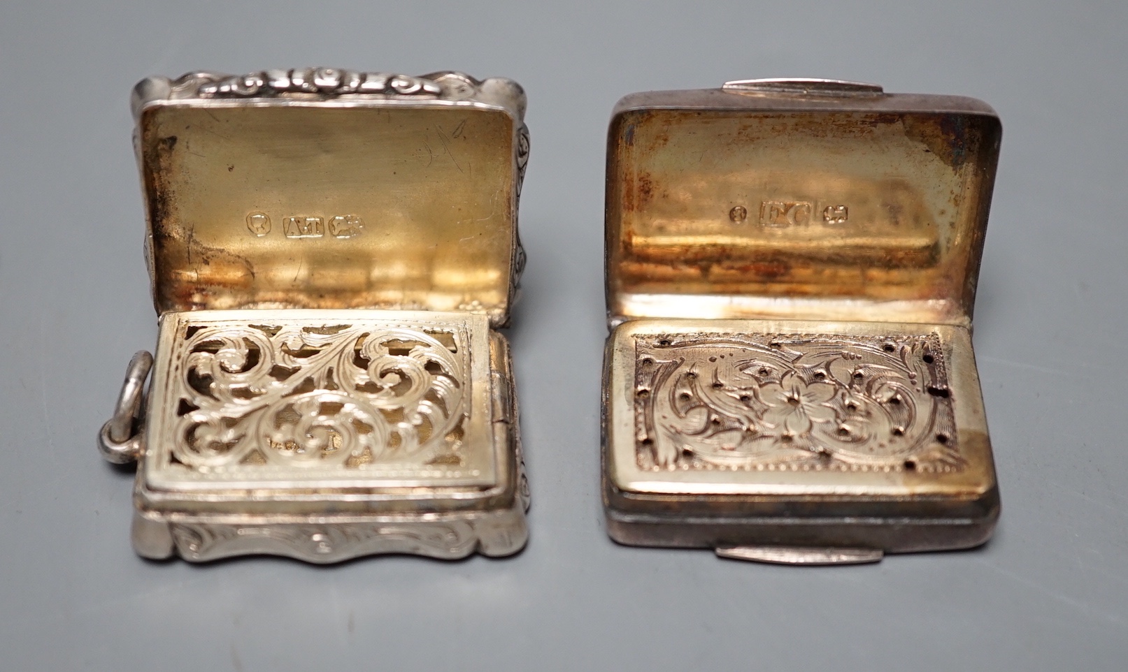 A Victorian engraved silver shaped rectangular vinaigrette, Alfred Taylor, Birmingham, 30mm, 1857 and one other silver vinaigrette by Francis Clark, 30mm, with engraved monogram.